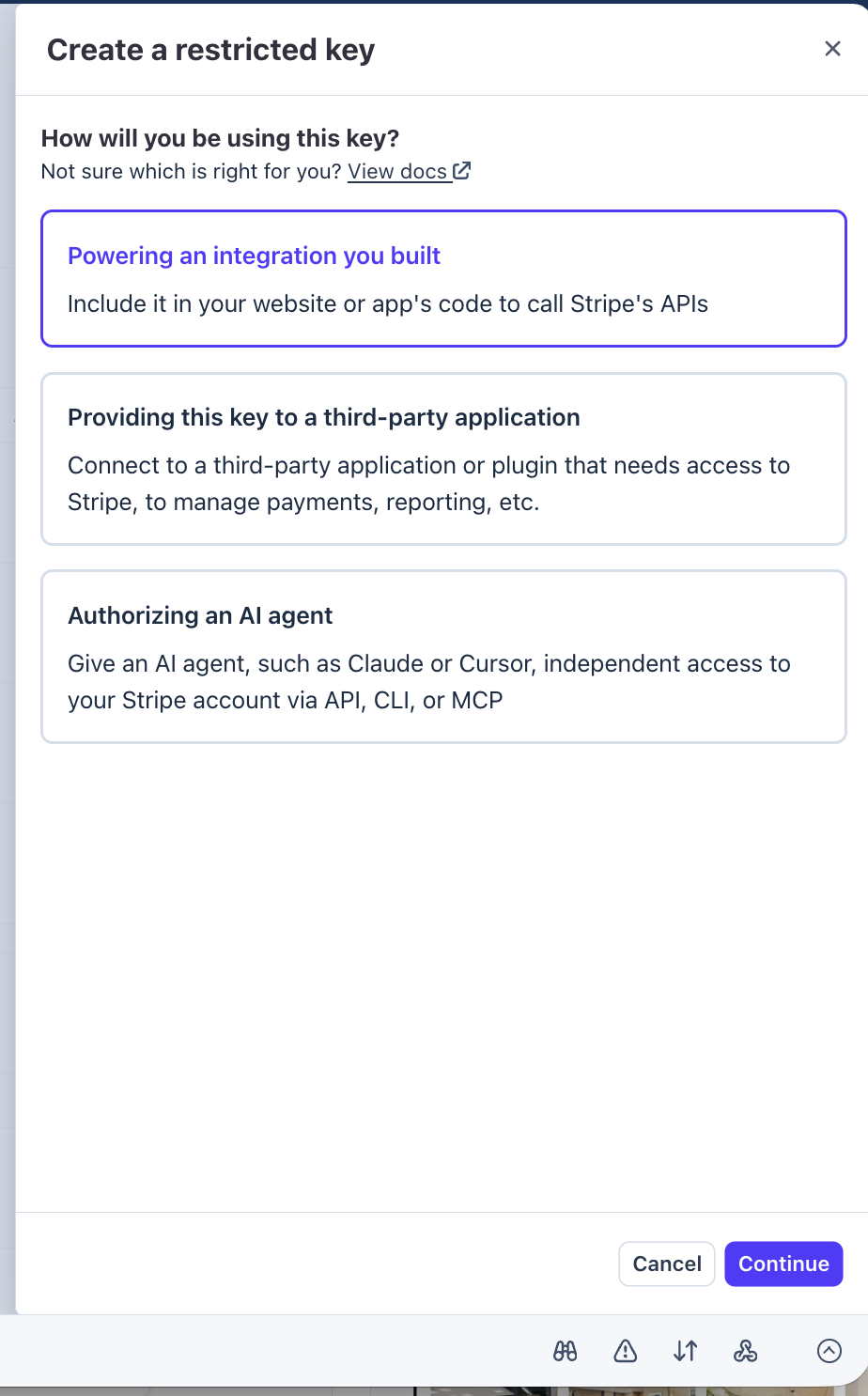 Stripe "Create a restricted key" dialog with three usage options; "Powering an integration you built" is selected.